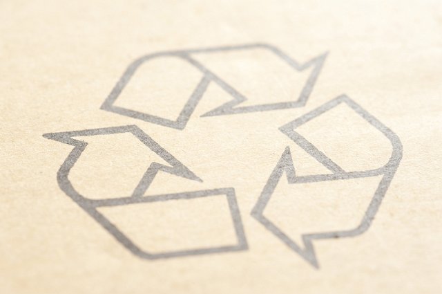 Cardboard with recycled or recycling arrows symbol on it