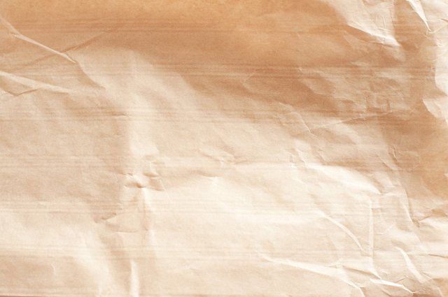 creased and crumpled brown paper surface with horizontal ribs