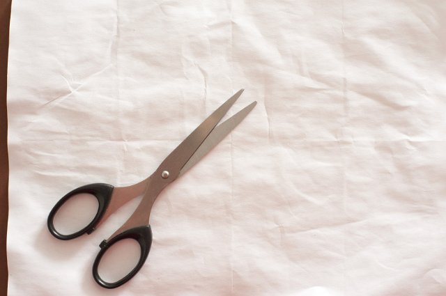 papers and scissors on a wrinkled creased background... now all we need is a stone