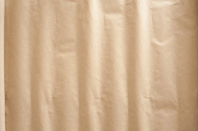 roll of paper with a wavy rippled effect caught in the light