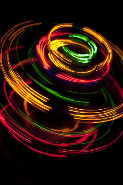 colorful series of overlapping curved lines of light glowing against a black background